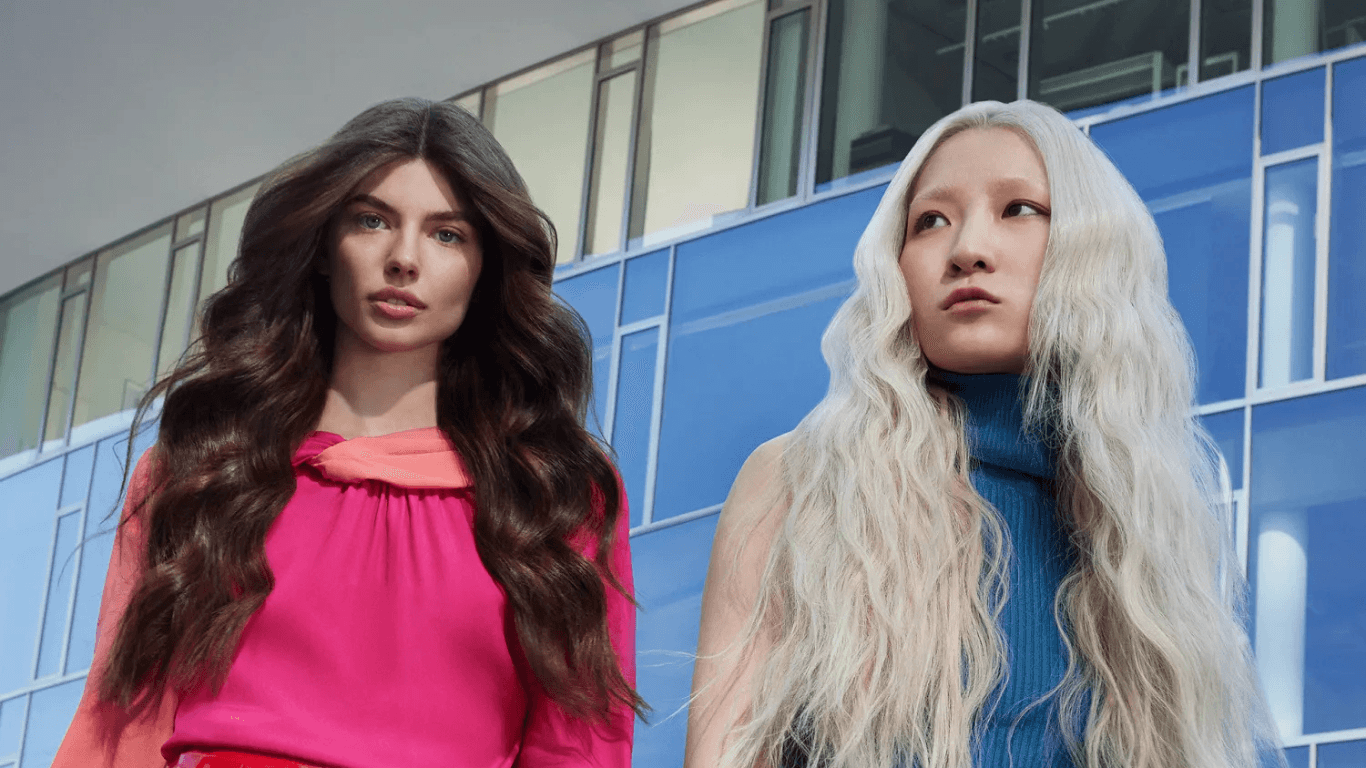 Two women with healthy, glossy coloured hair — showcasing the safe, vibrant results of AlfaParf colour at The Vintage Avenue salon in Biggleswade, Bedfordshire.