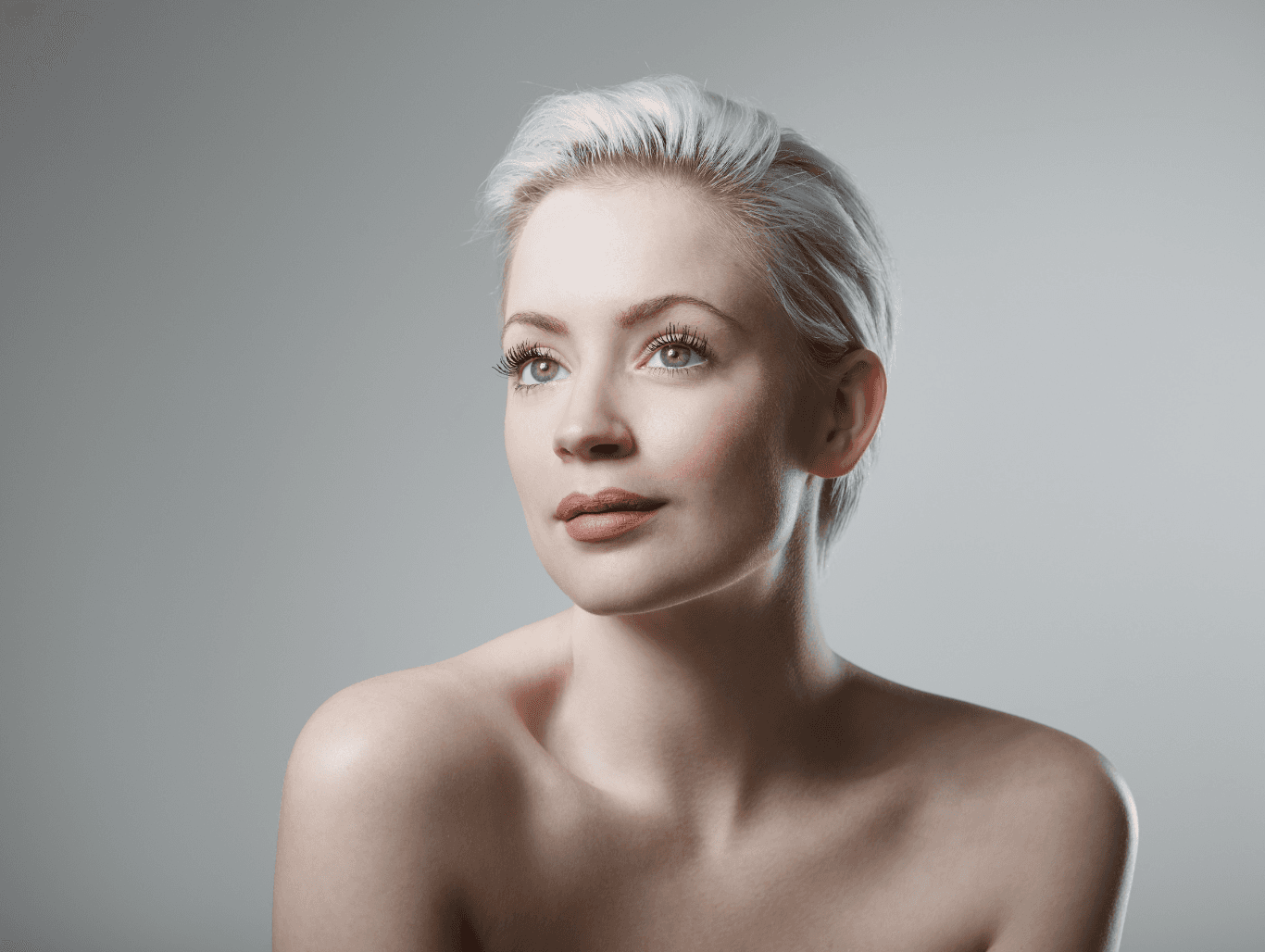 Woman with a chic, icy blonde pixie cut and clean root regrowth, showcasing the results of a professional Bleach Root Regrowth service – The Vintage Avenue, Biggleswade