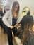 Chloe Collins, Senior Designer at The Vintage Avenue, brushing through wet hair before styling a client in the salon.
