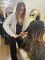 Chloe Collins, Senior Designer at The Vintage Avenue, brushing through wet hair before styling a client in the salon.