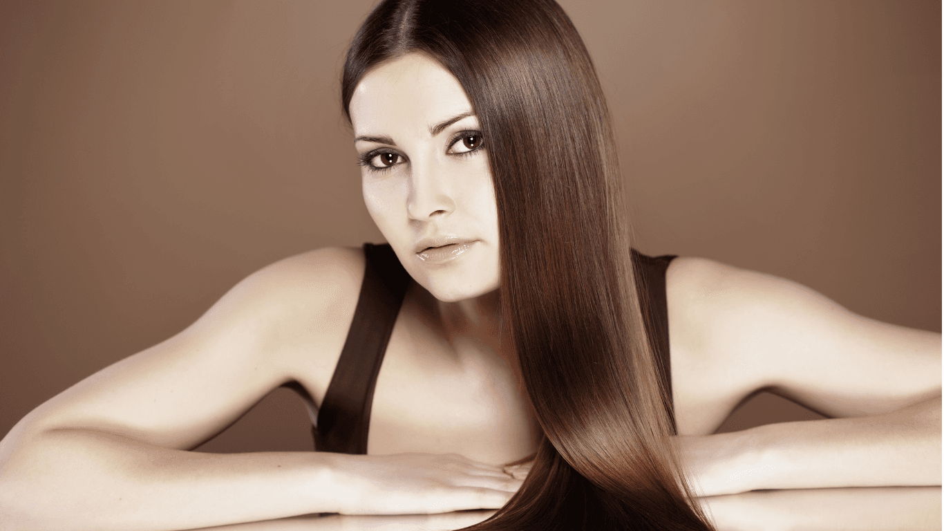 Woman with sleek, frizz-free hair after keratin straightening treatment at The Vintage Avenue in Biggleswade