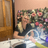 Katie, nail technician at Vintage Avenue, smiling while performing a manicure treatment